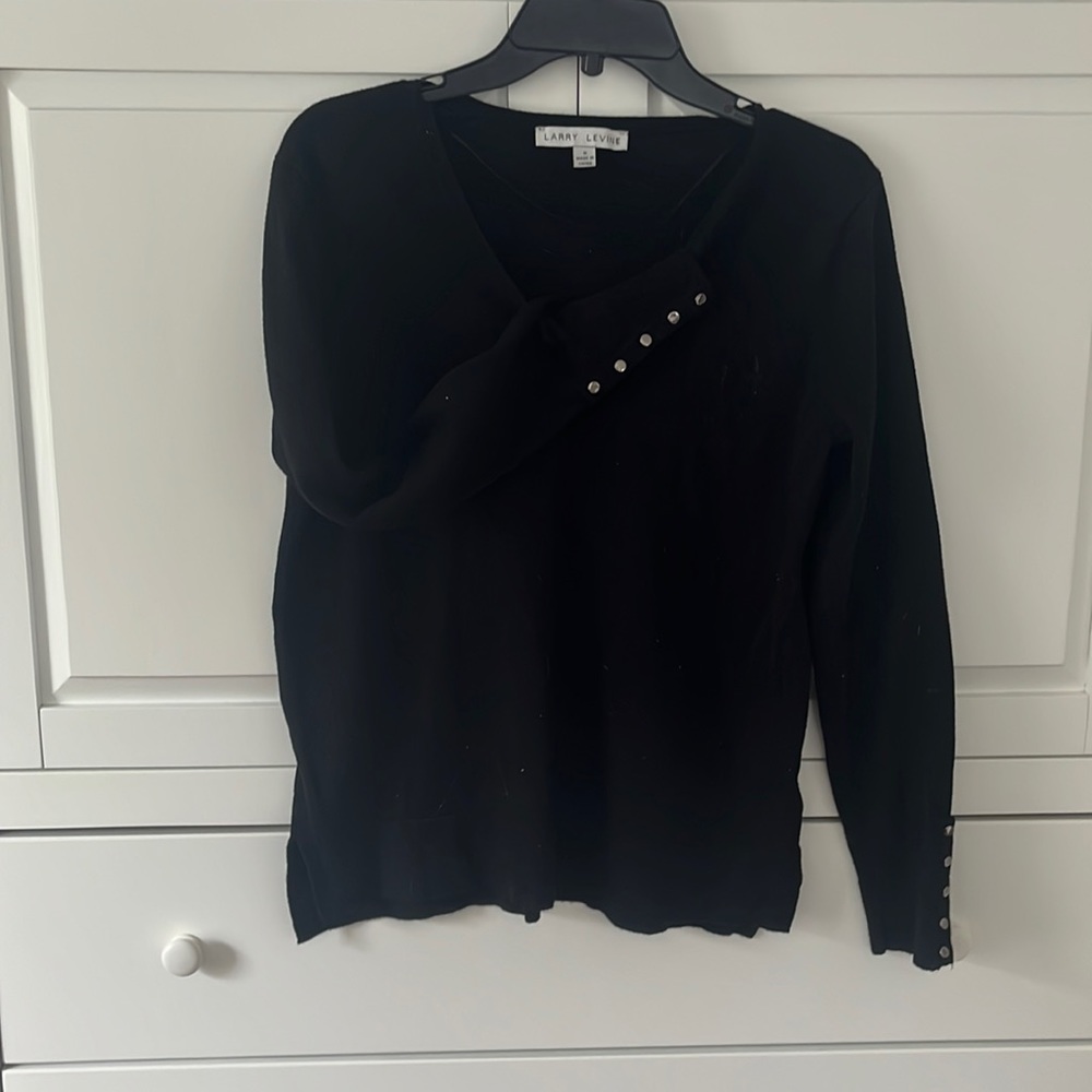V-neck sweater with silver buttons at bottom of the sleeve